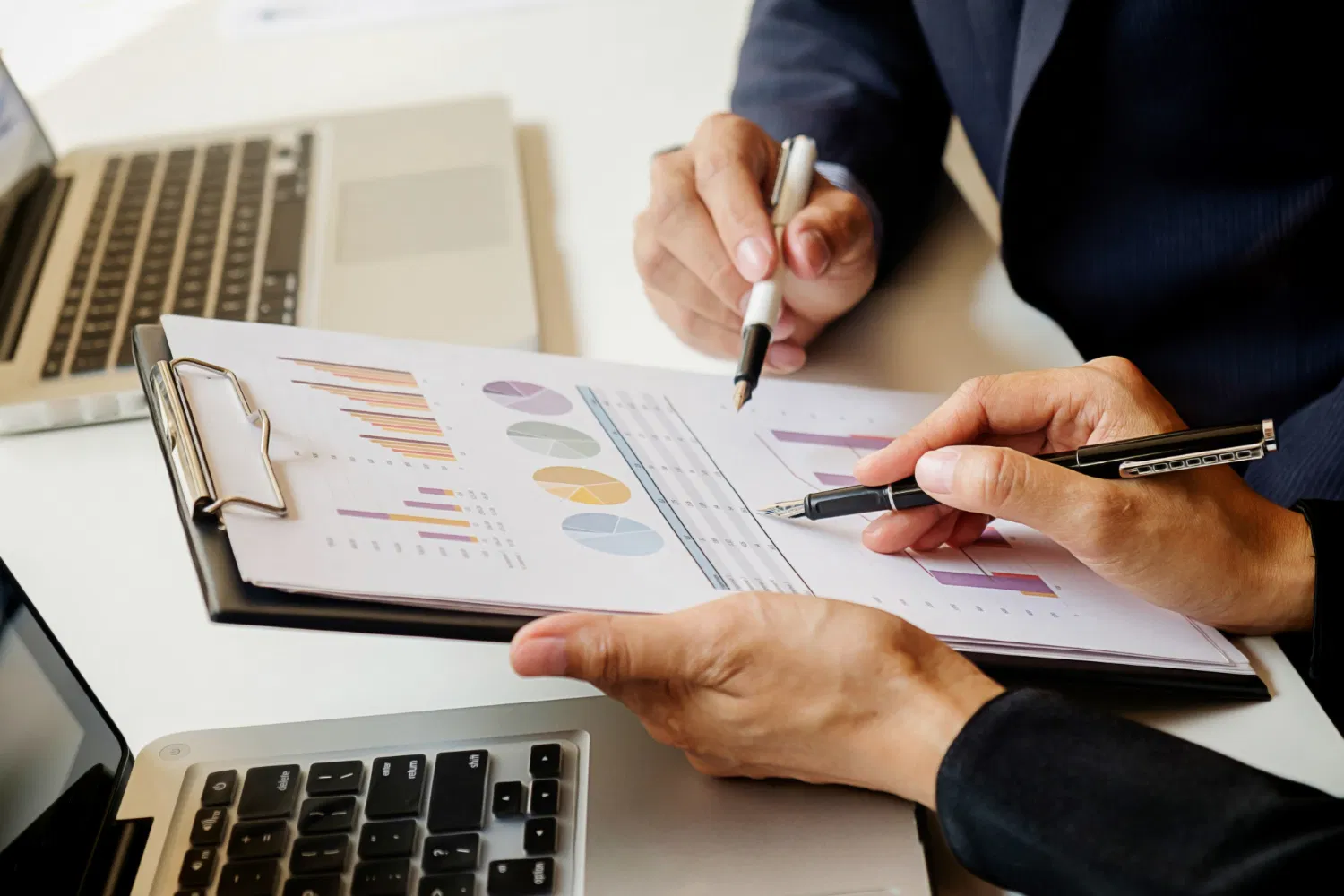 Two professionals reviewing charts and data reports, WaveMed audit of online marketing activities