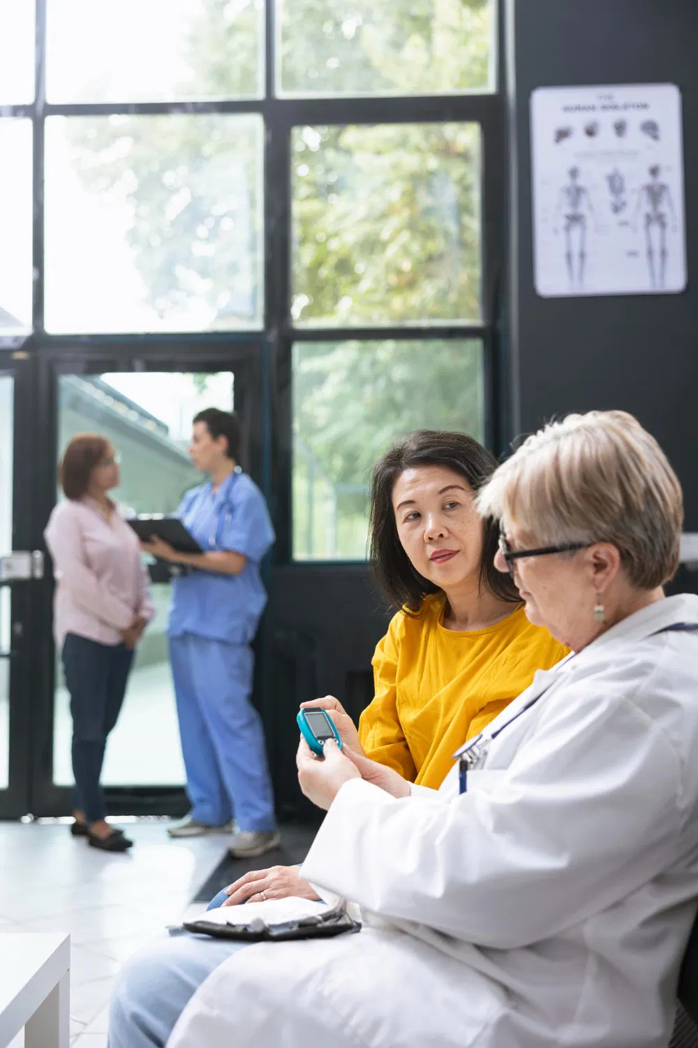 Doctor explaining health information to patient in clinic, WaveMed materials for medical facilities