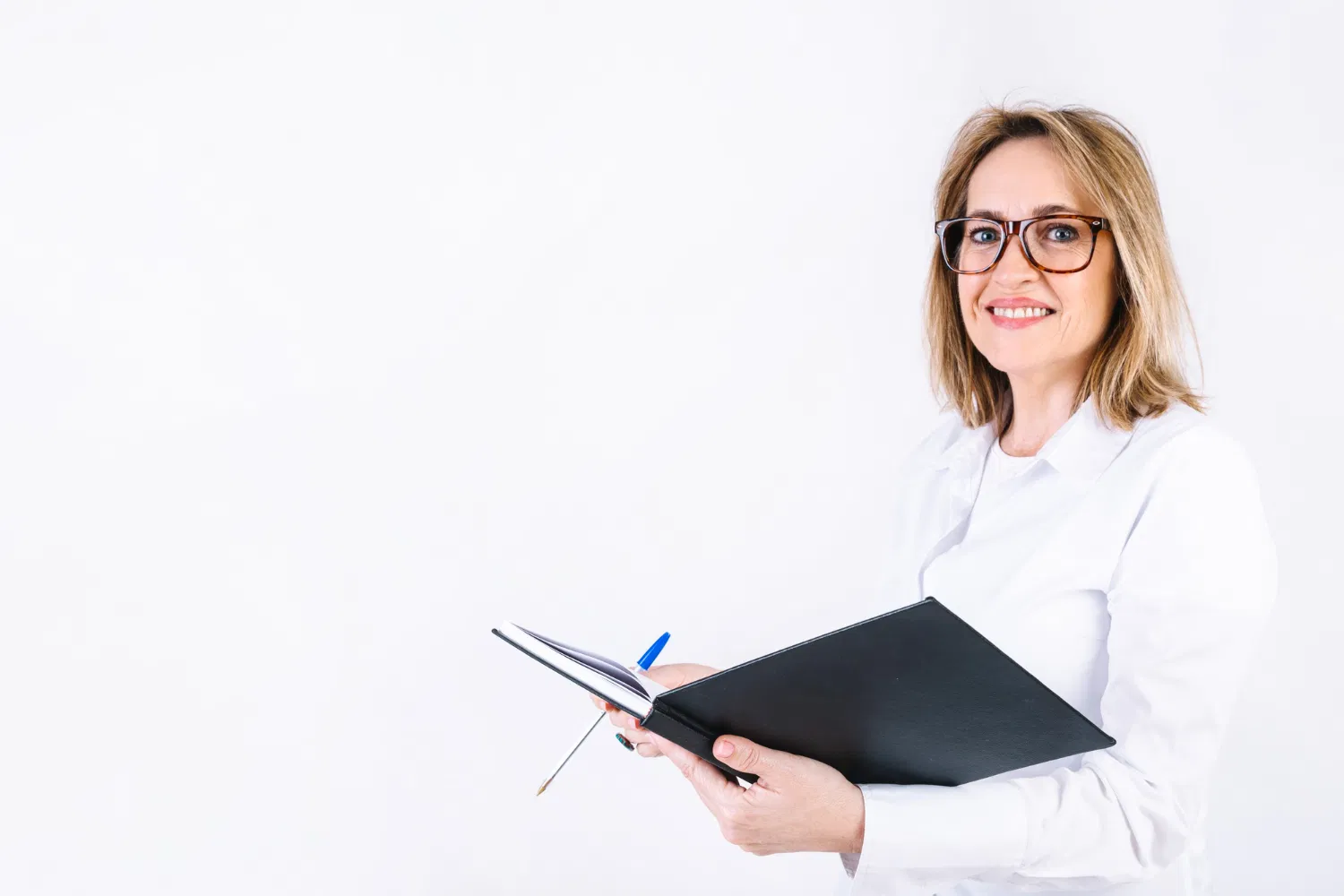 Doctor holding notebook and smiling, WaveMed medical education content development
