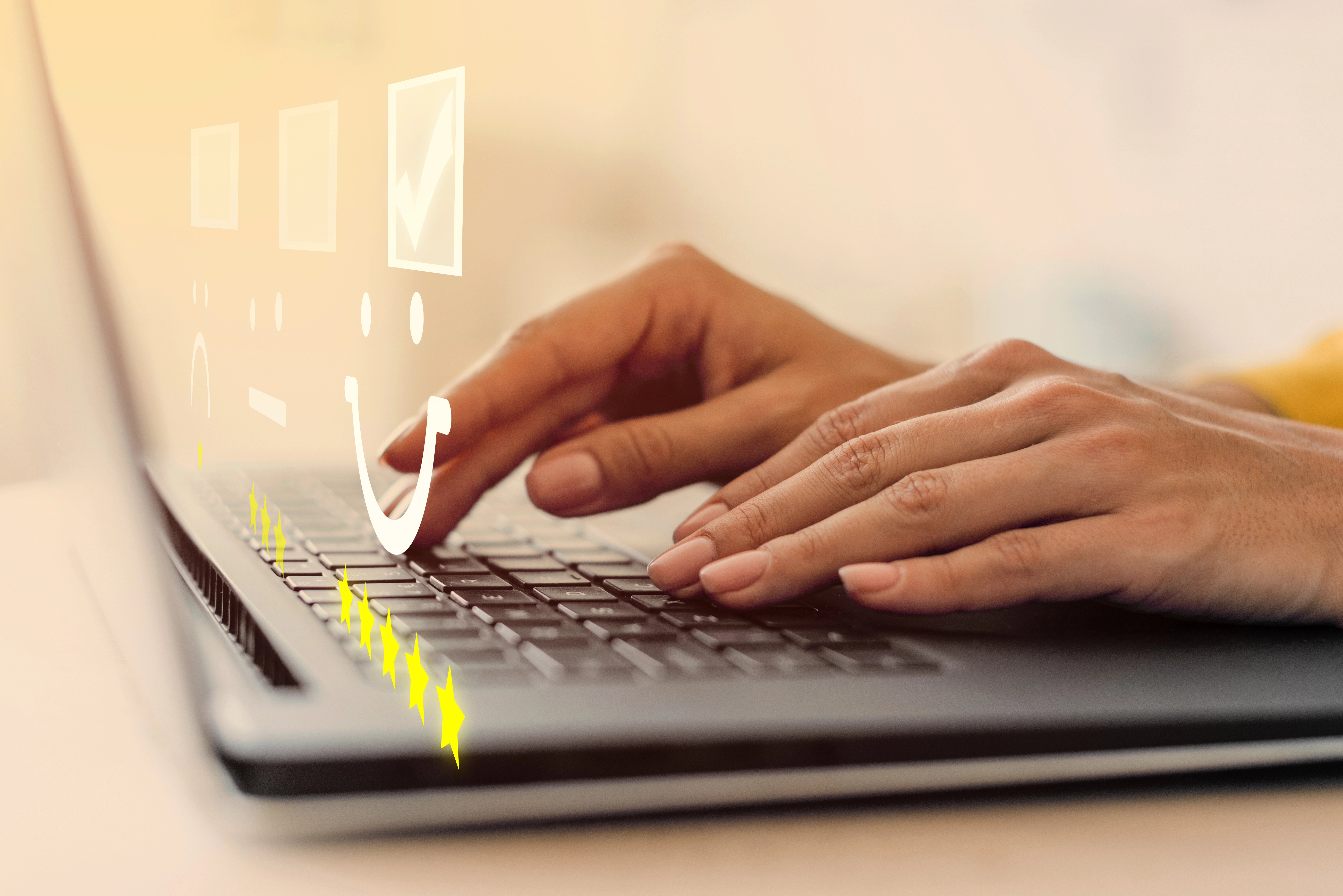 Hands typing on a laptop with smiley face and rating icons — concept of content quality review and feedback assessment by WaveMed Medical Communications Agency