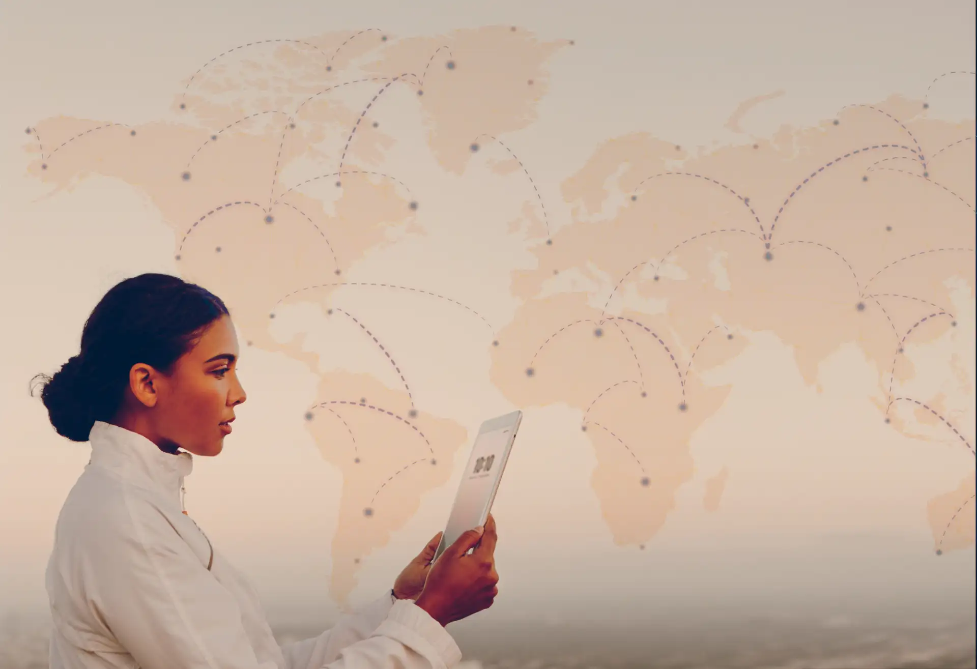 Specialist using a tablet in front of a world map visualizing WaveMed's global reach in medical communication