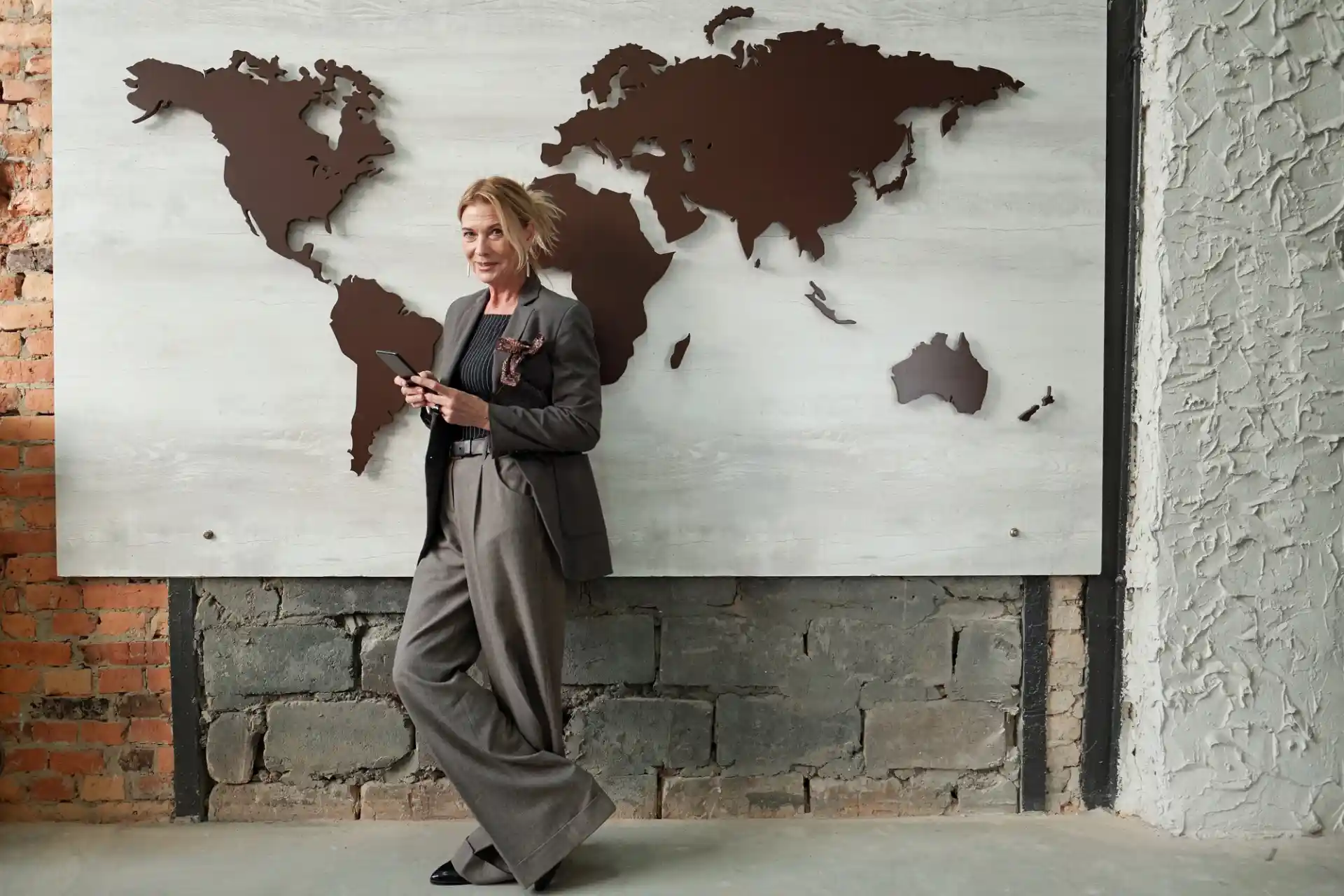 WaveMed medical communications specialist standing by a world map, symbolizing global healthcare collaboration