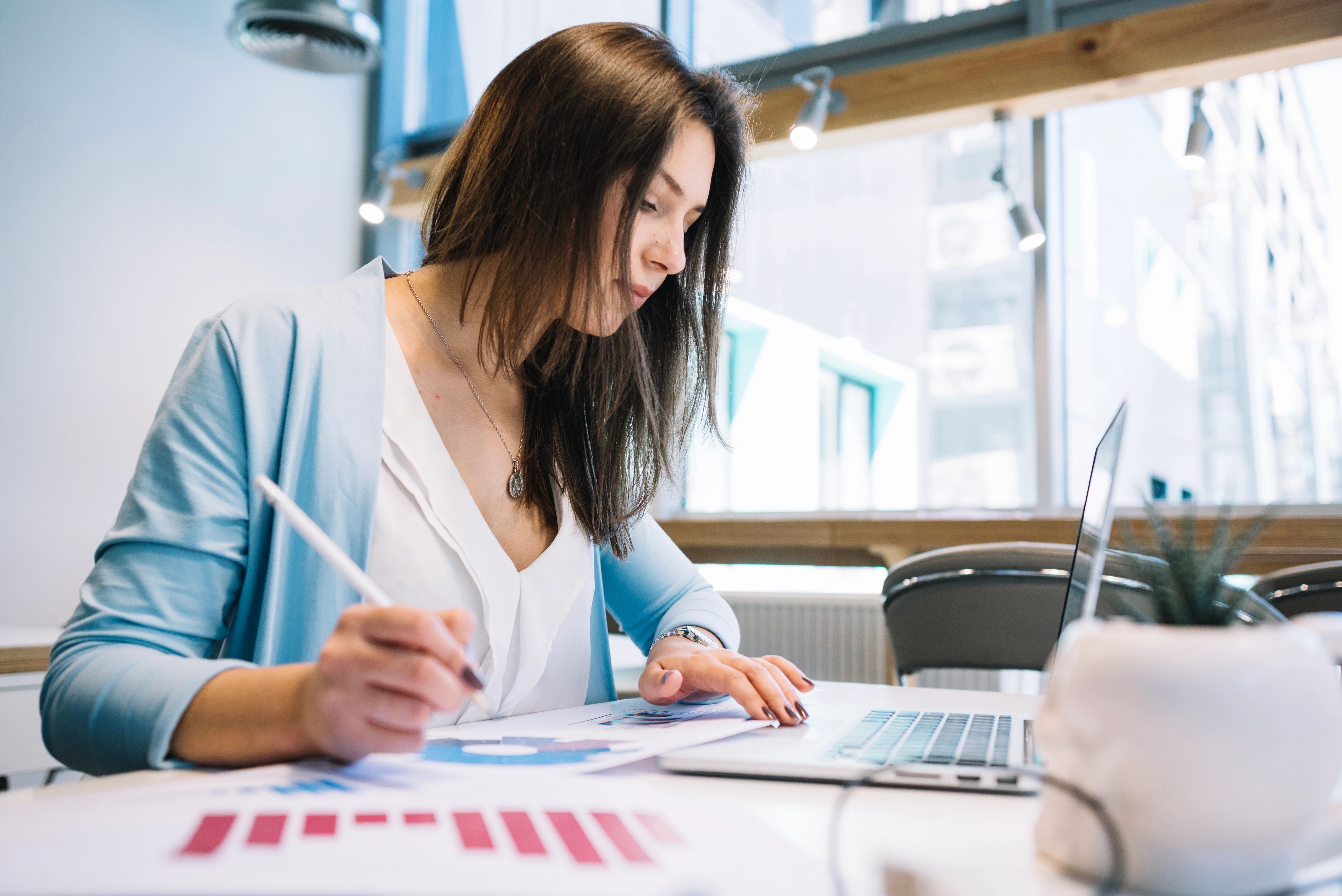 Woman analysing medical research data on a laptop — concept of literature searches and scientific report preparation by WaveMed Medical Comms
