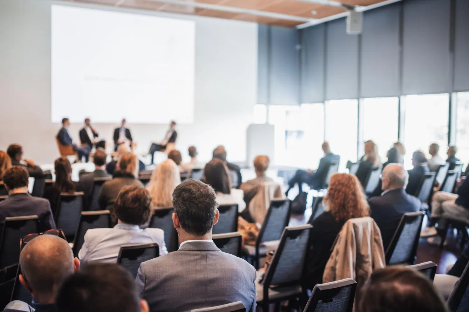 Attendees listening to a medical expert panel during a conference, event supported by WaveMed agency