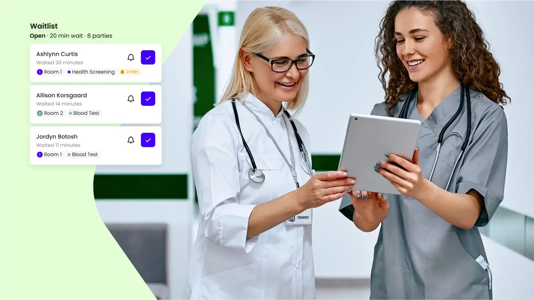 Healthcare professionals discussing the patient waitlist on a tablet in a hospital setting