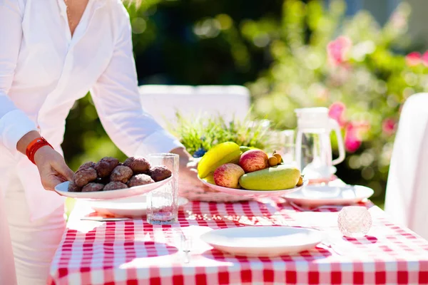 depositphotos_465748902-stock-photo-woman-setting-table-outdoors-garden.webp