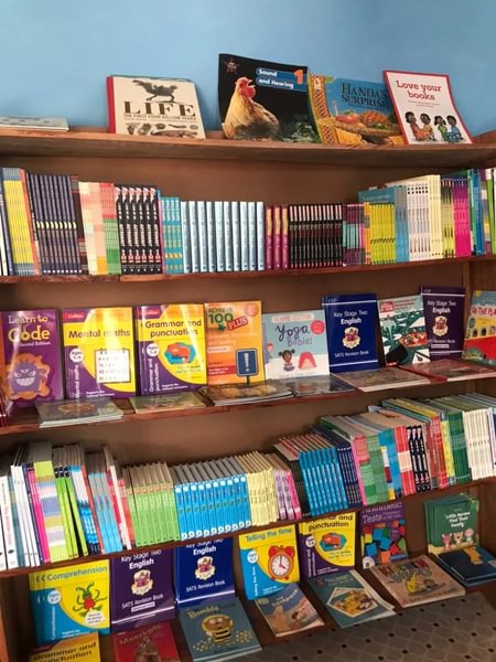 Bokhylle med barnebøker i American Calvary Baptist Explorer Library i Sierra Leone