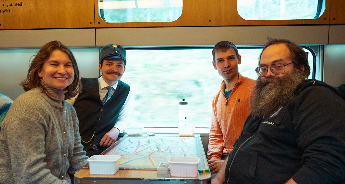 Finalistene poserer rundt bordet før finalen i NM i Ticket to Ride 2025