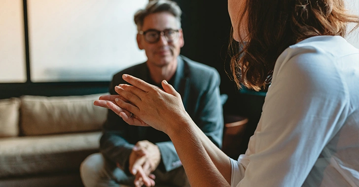 Close-up of a conversation in a softly lit room. 