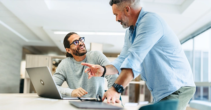 Two men collaborate in a modern office setting. 
