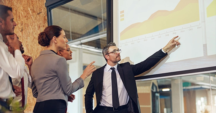 A business presentation in a modern office setting. 