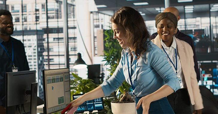 A bright, modern office scene with three colleagues.