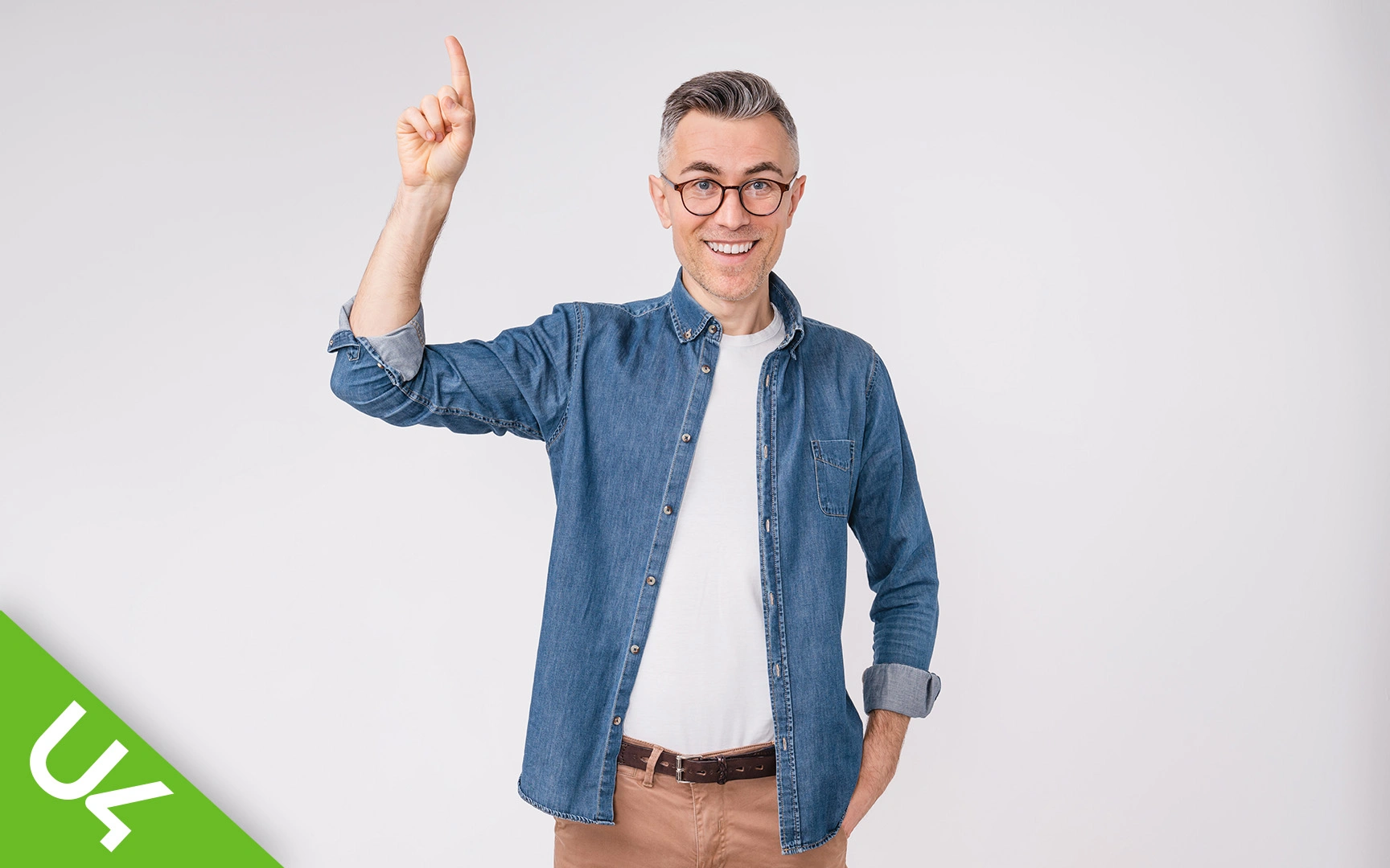 smiling man with one hand raised