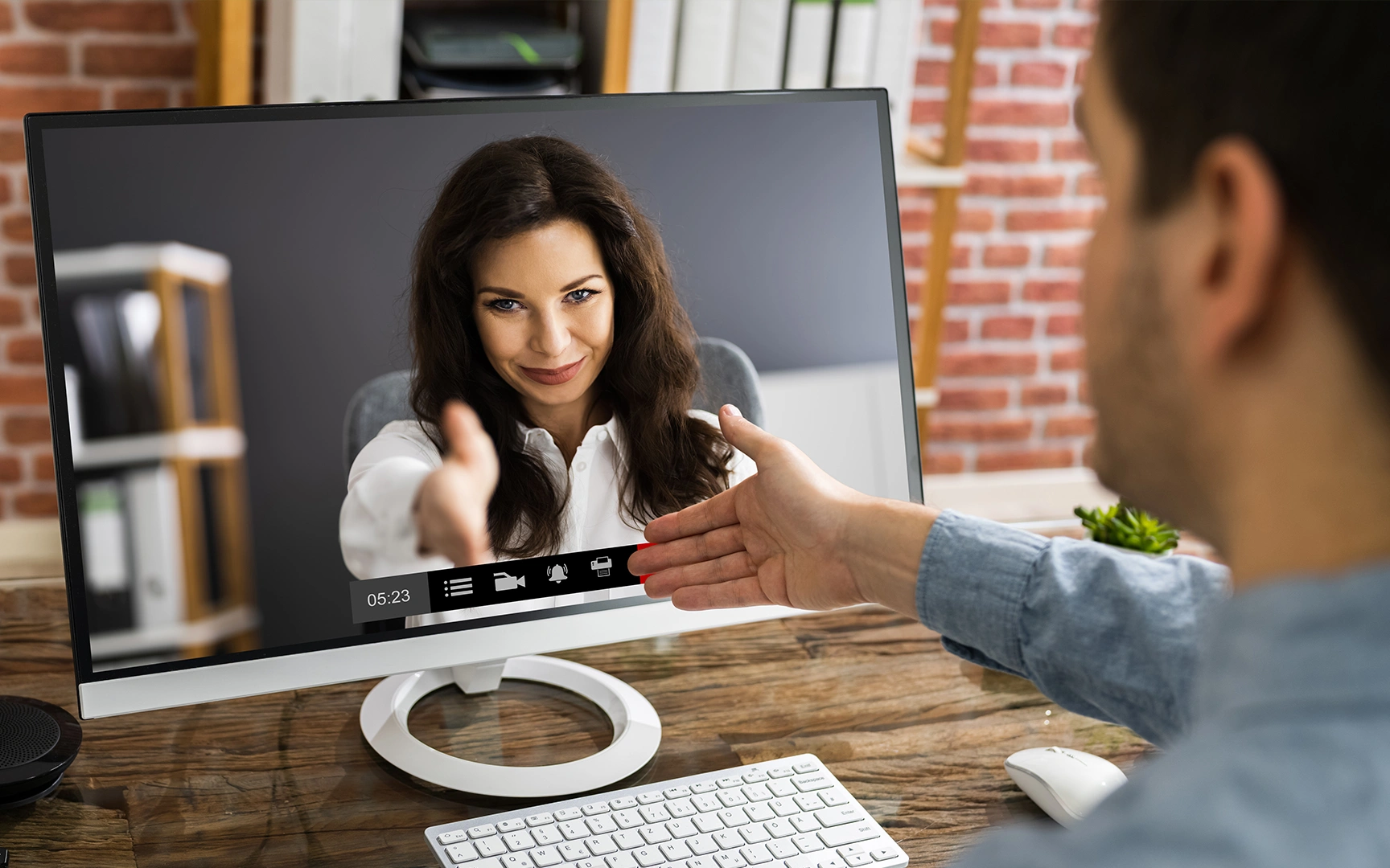 people shaking hands through computer screen