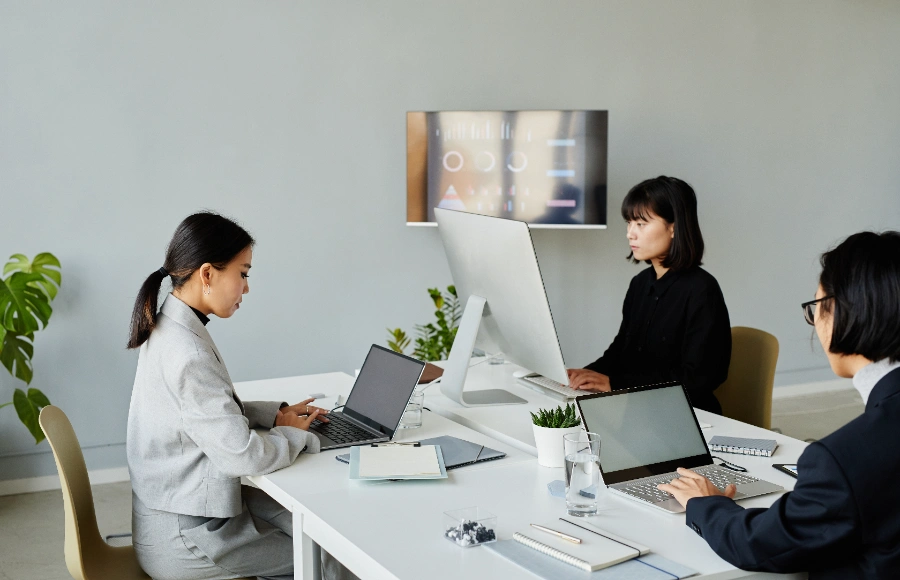 Persons working in front of a desk