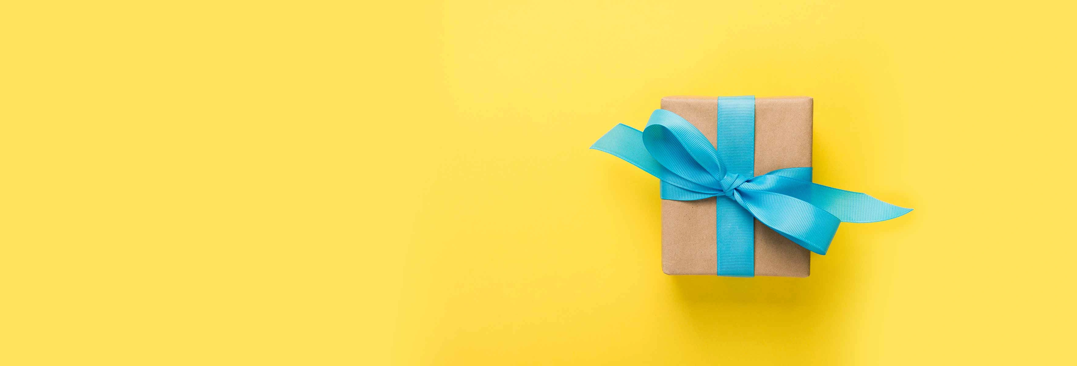 a parcel with a blue ribbon on a yellow background