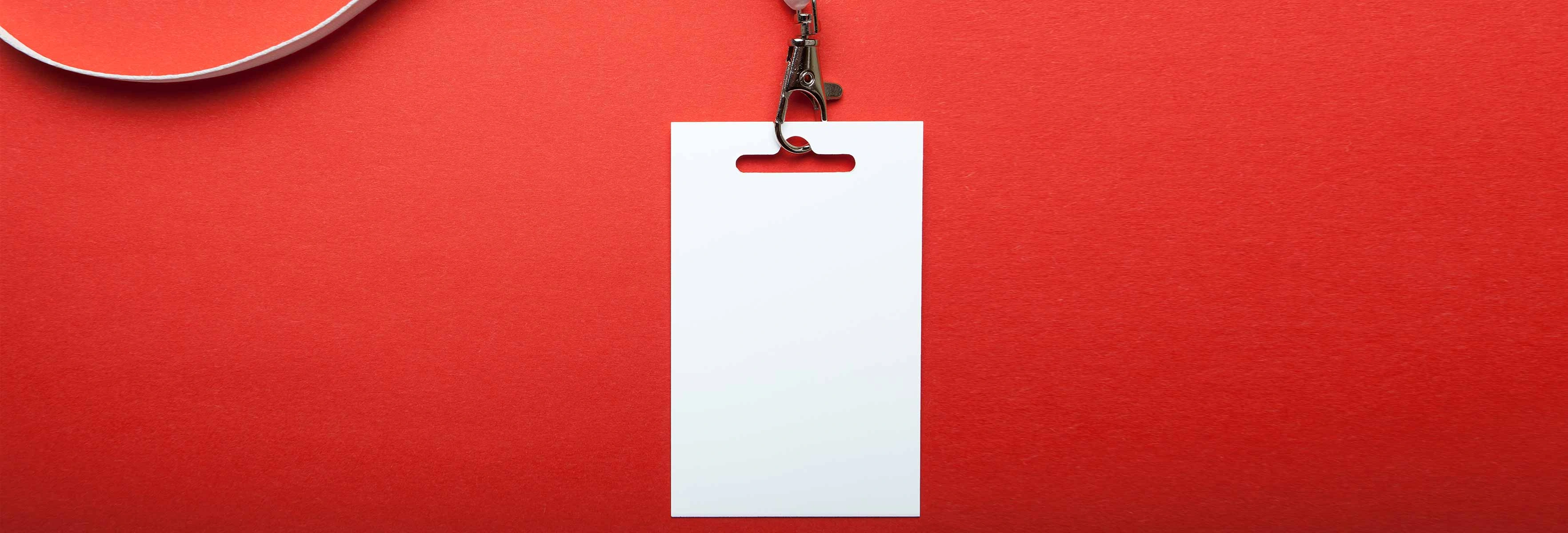 blank white ID on a white lanyard on a red background