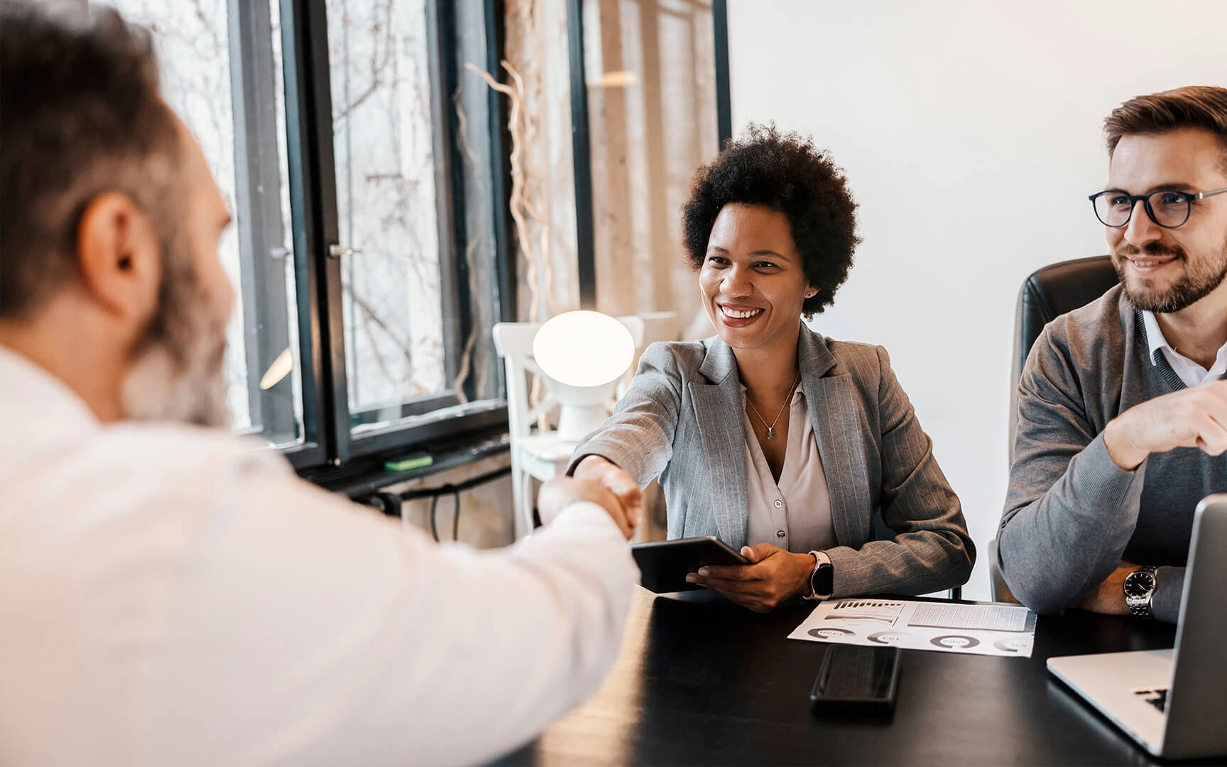 people sit at a table smiling