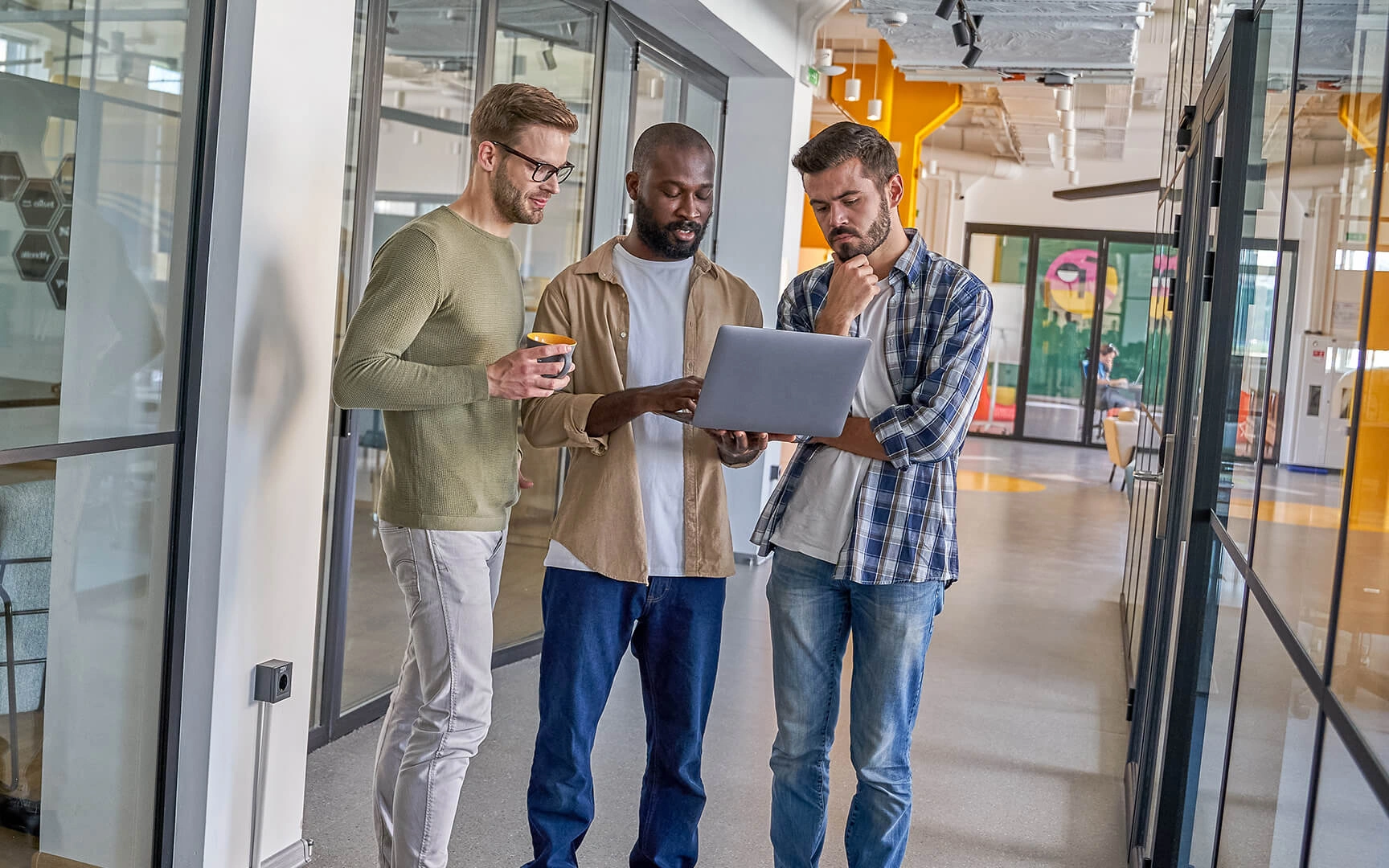 3 men with a laptop