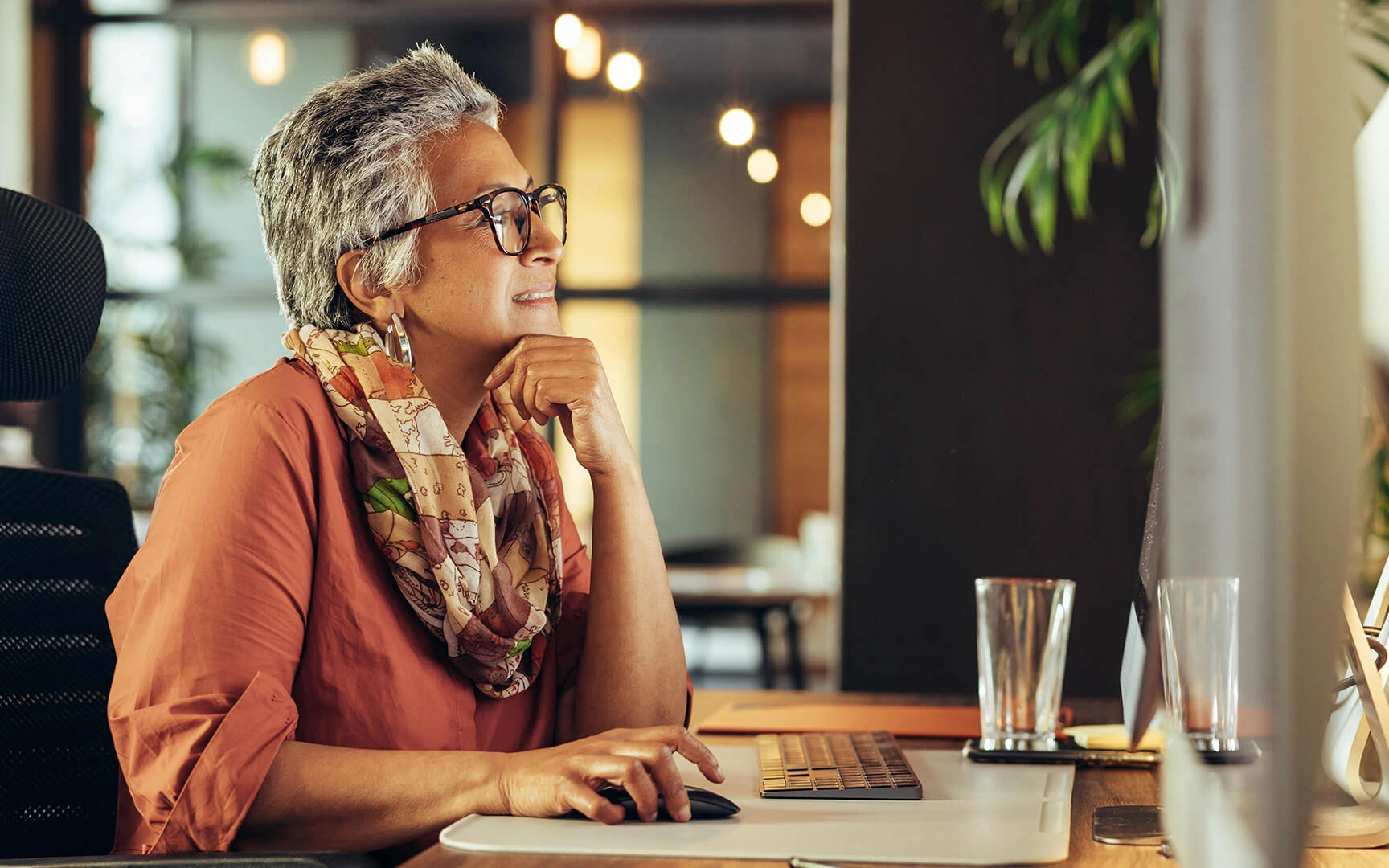 old woman sit in a desk