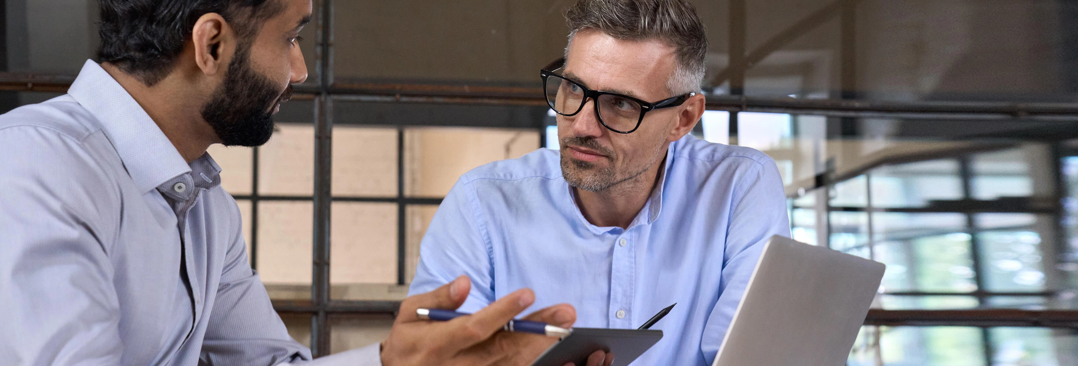 Men talking with laptop