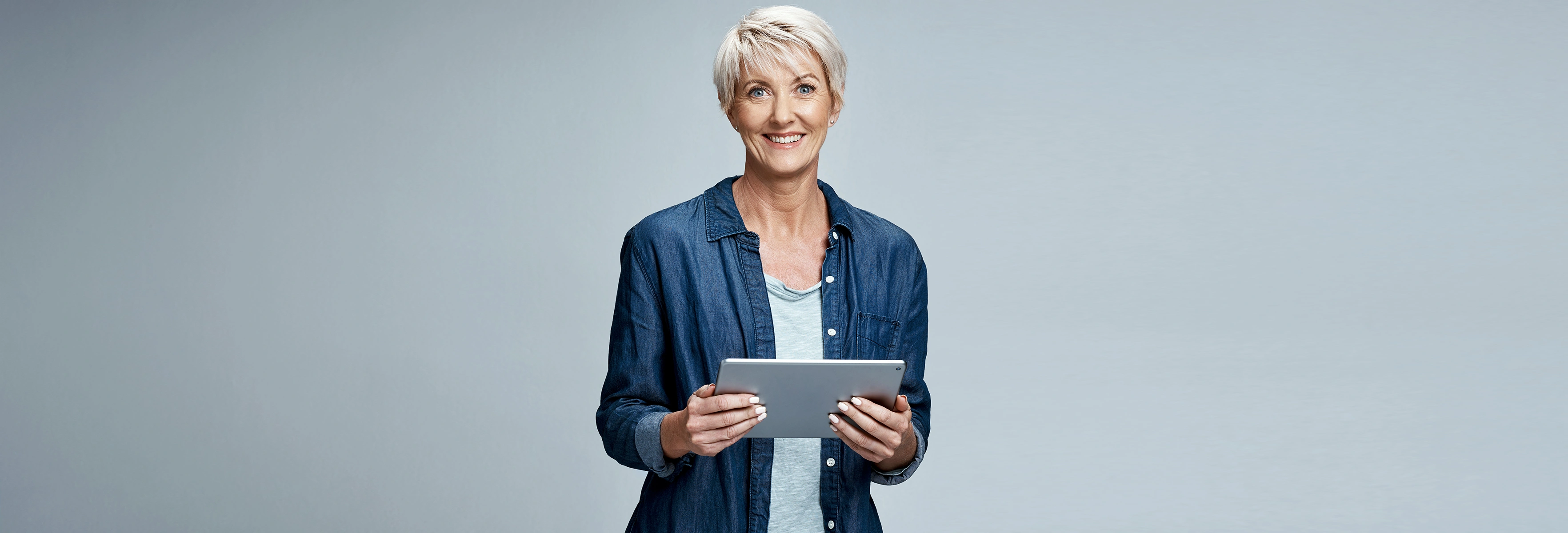 person smiling with Ipad in hands