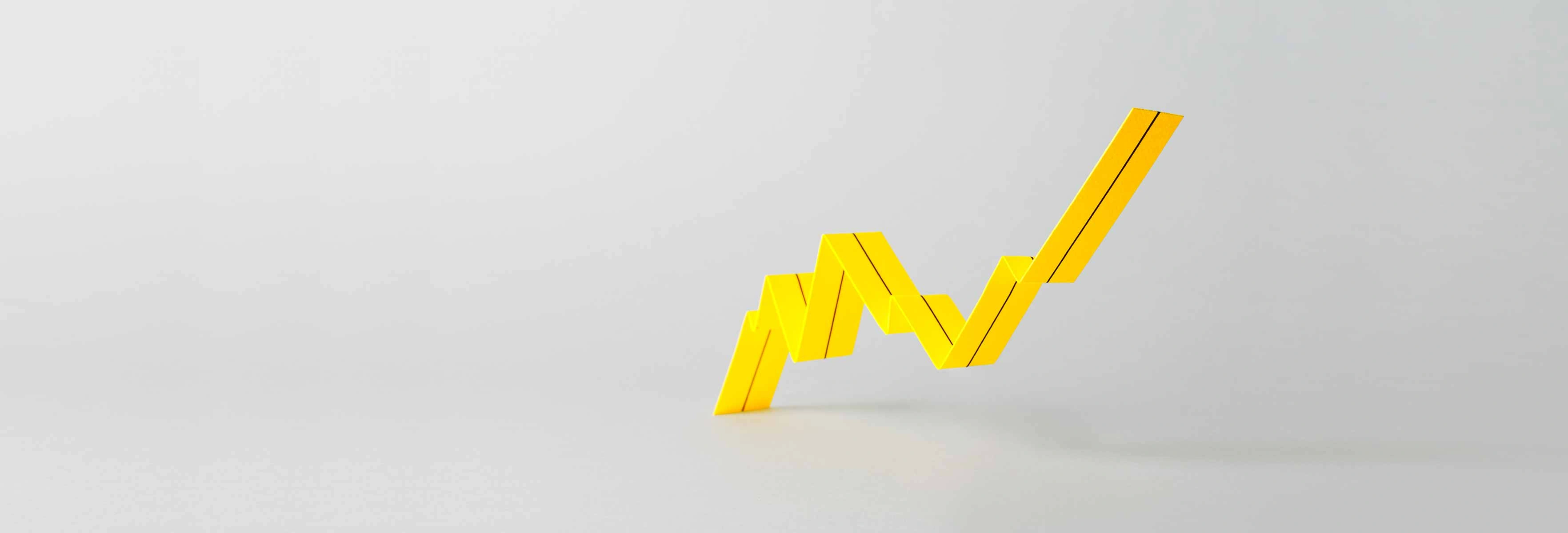 a 3 dimensional bar chart in yellow showing a steady increase on a grey background