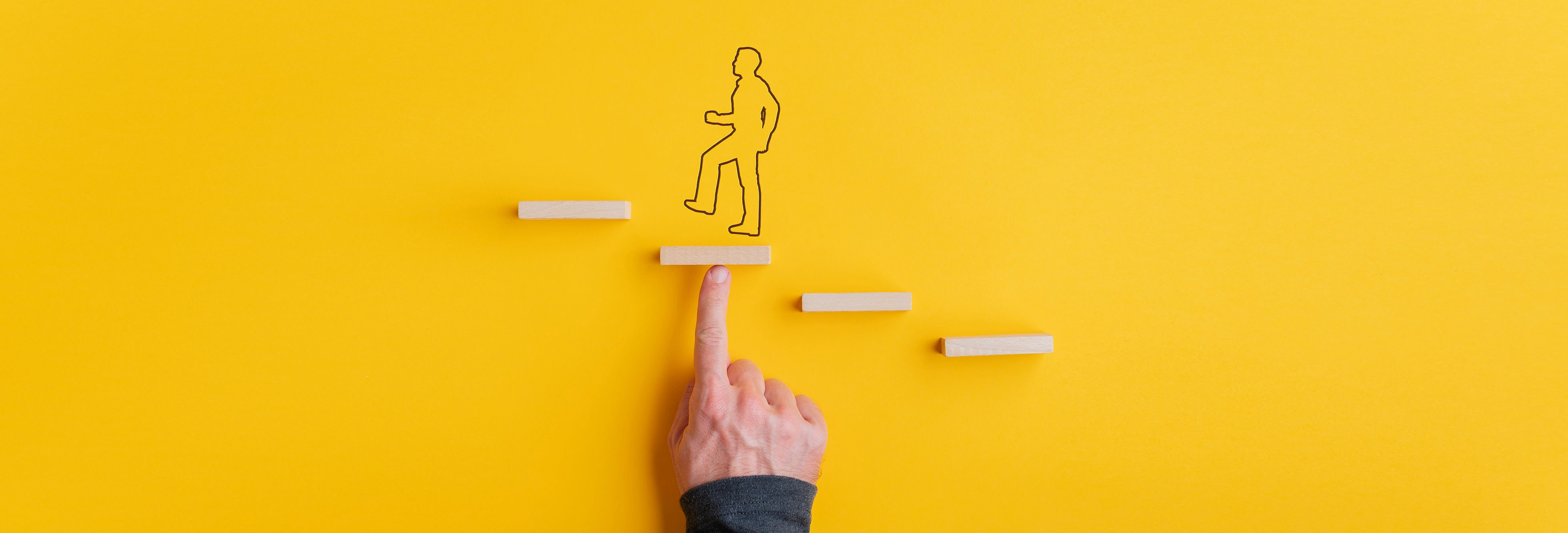 Finger pointing at drawn man going up small steps 