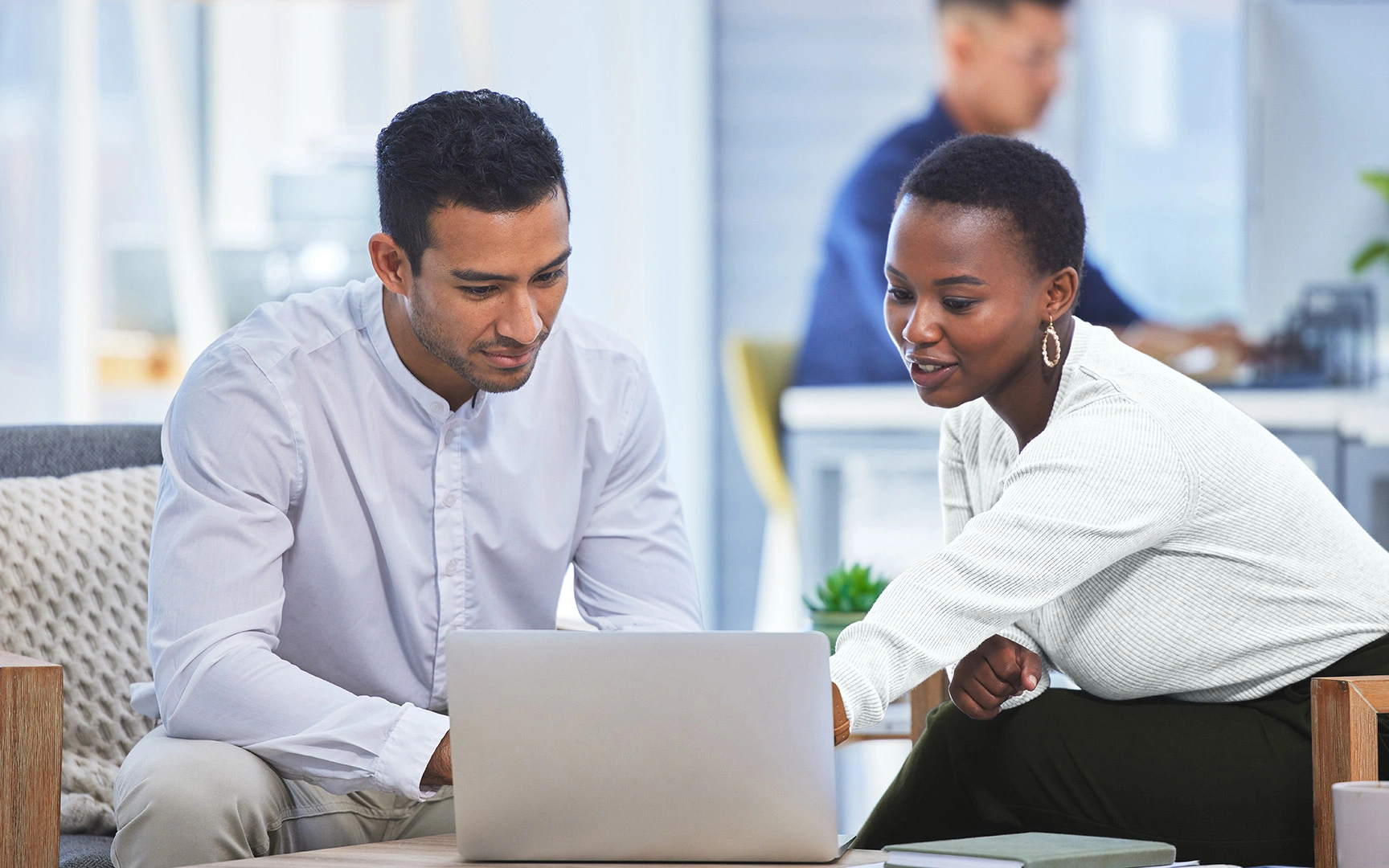 Businesspeople looking at laptop