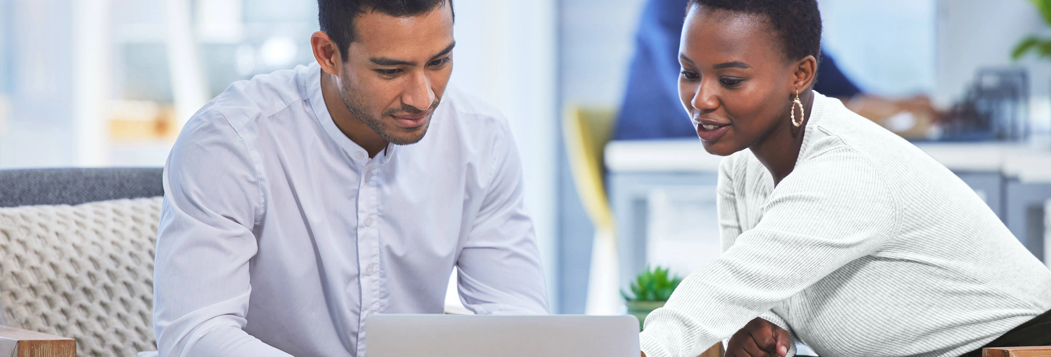 Businesspeople looking at laptop