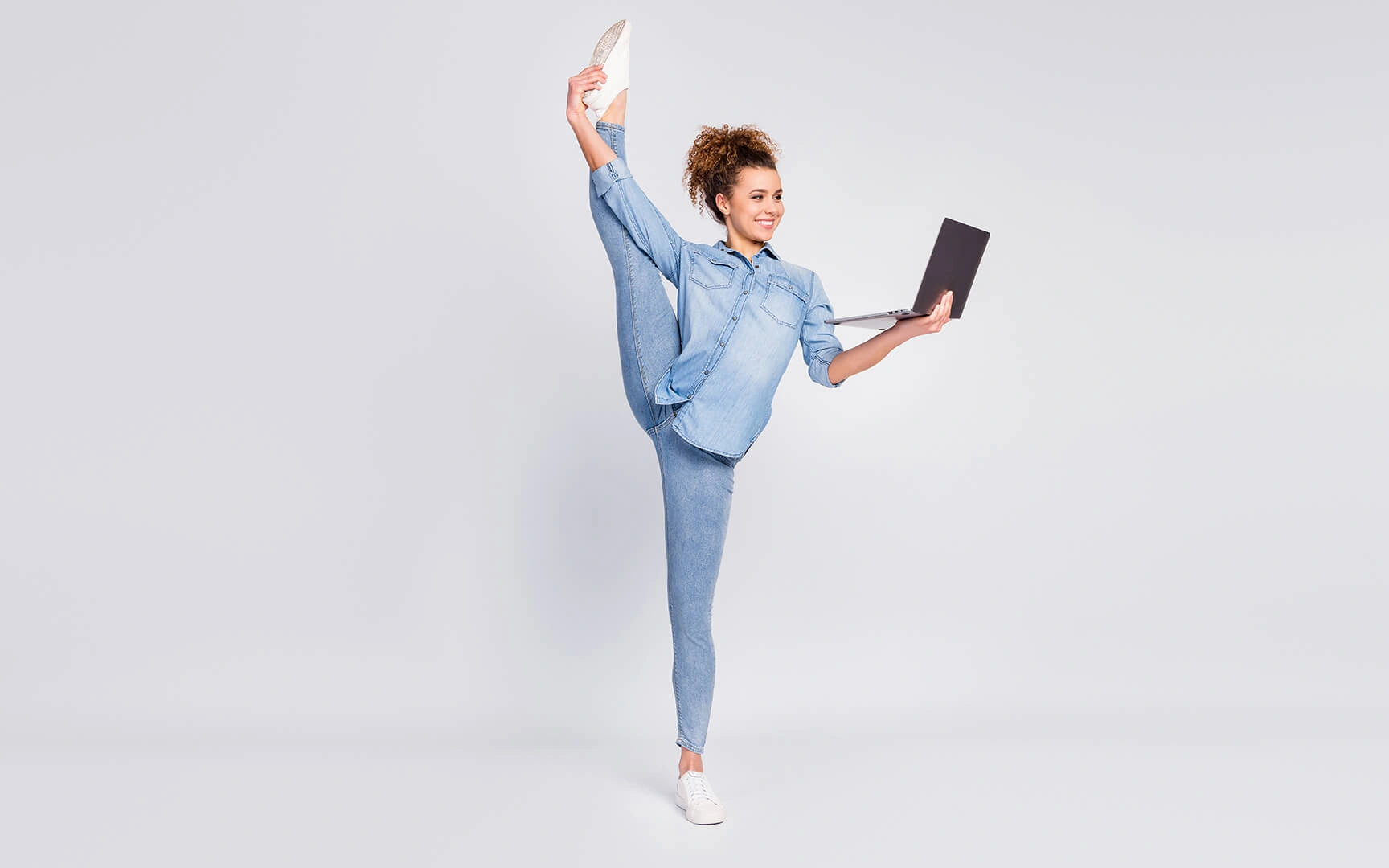 Flexible woman with laptop
