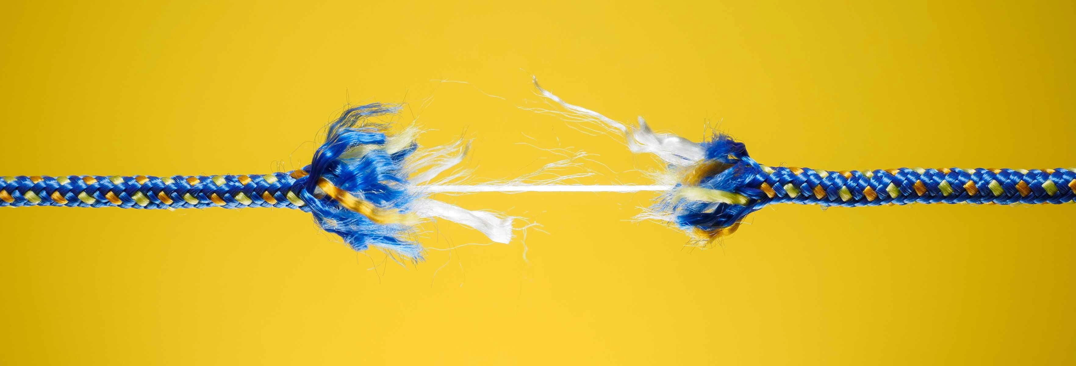 breaking rope on yellow background