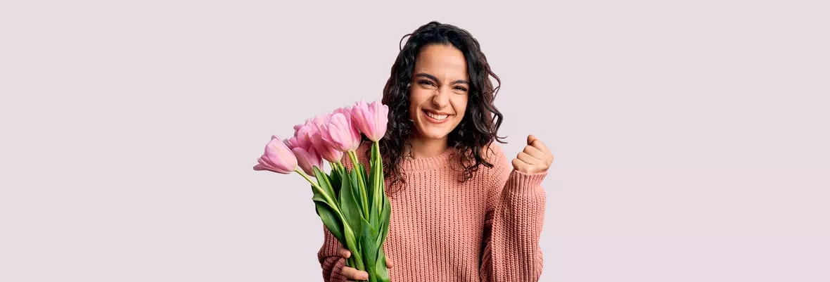 Happy woman with flowers in her hand