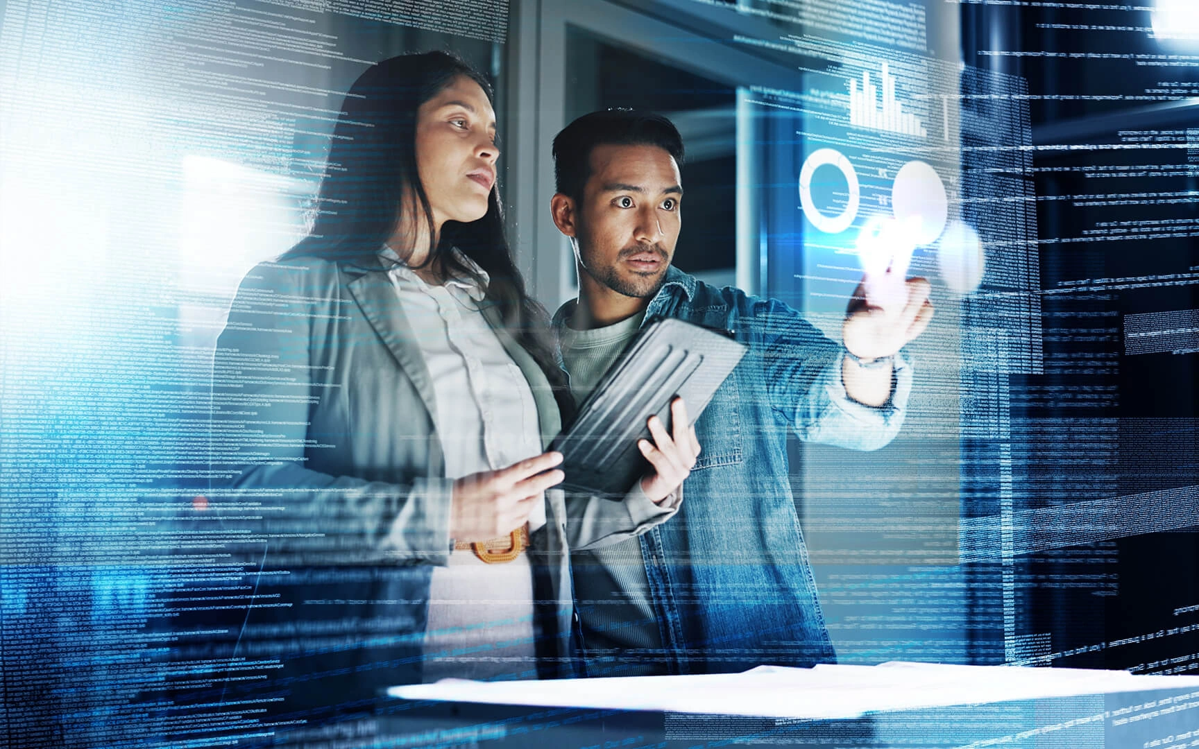 Two people interacting with futuristic holographic interfaces, analyzing data and charts in a high-tech office environment.
