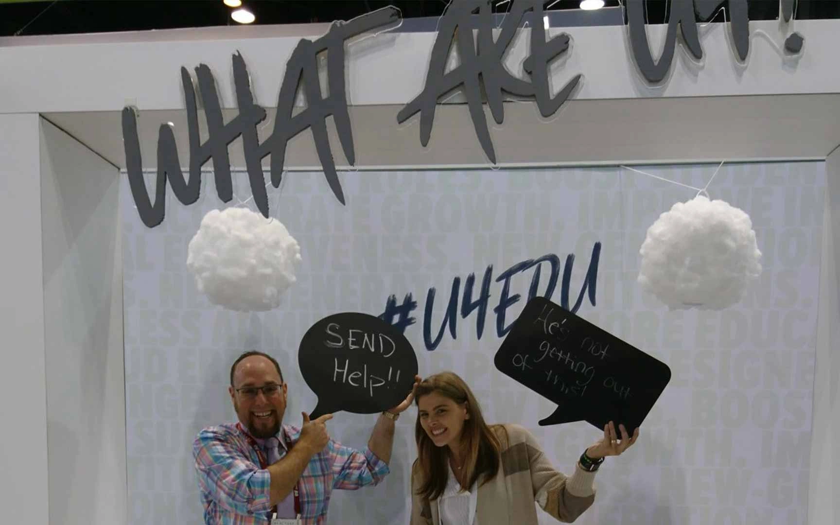 a man and a girl holding up speech bubble shape cards with text