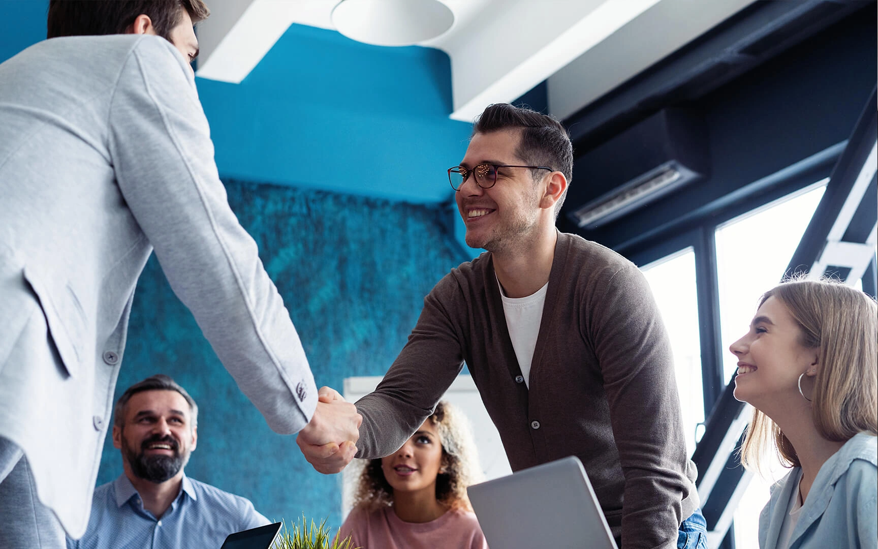 Smart dressed men shaking hands.