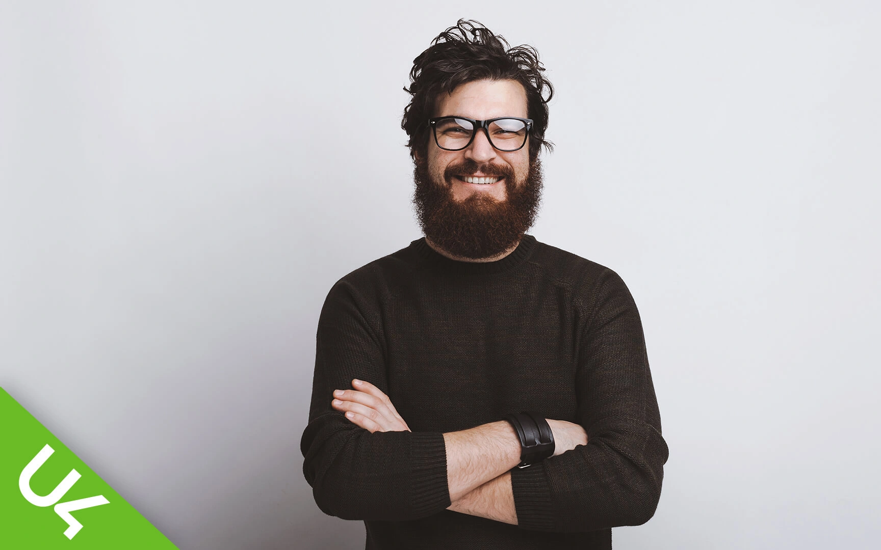 Smiling man with arms folded