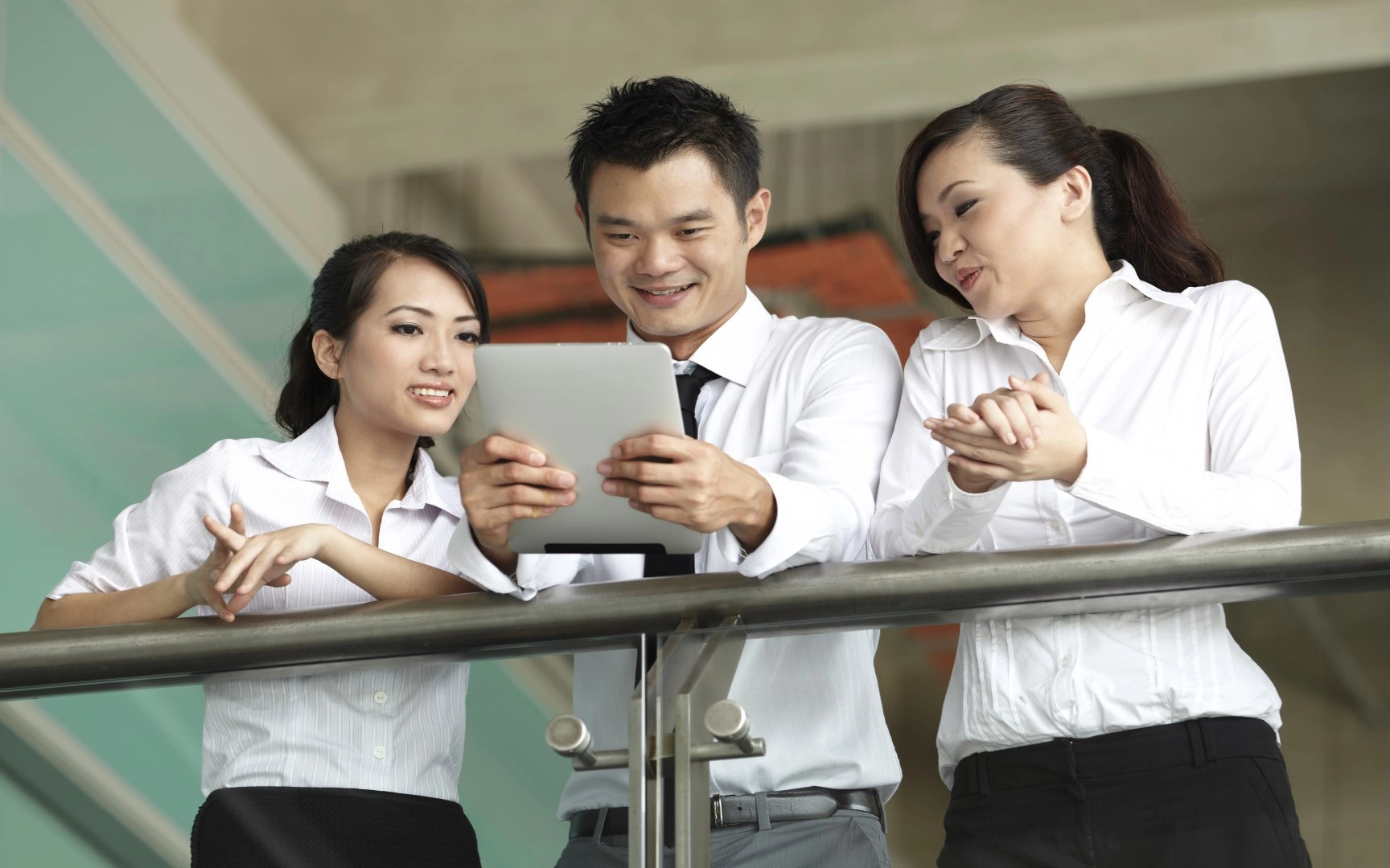 Three persons looking at iPad