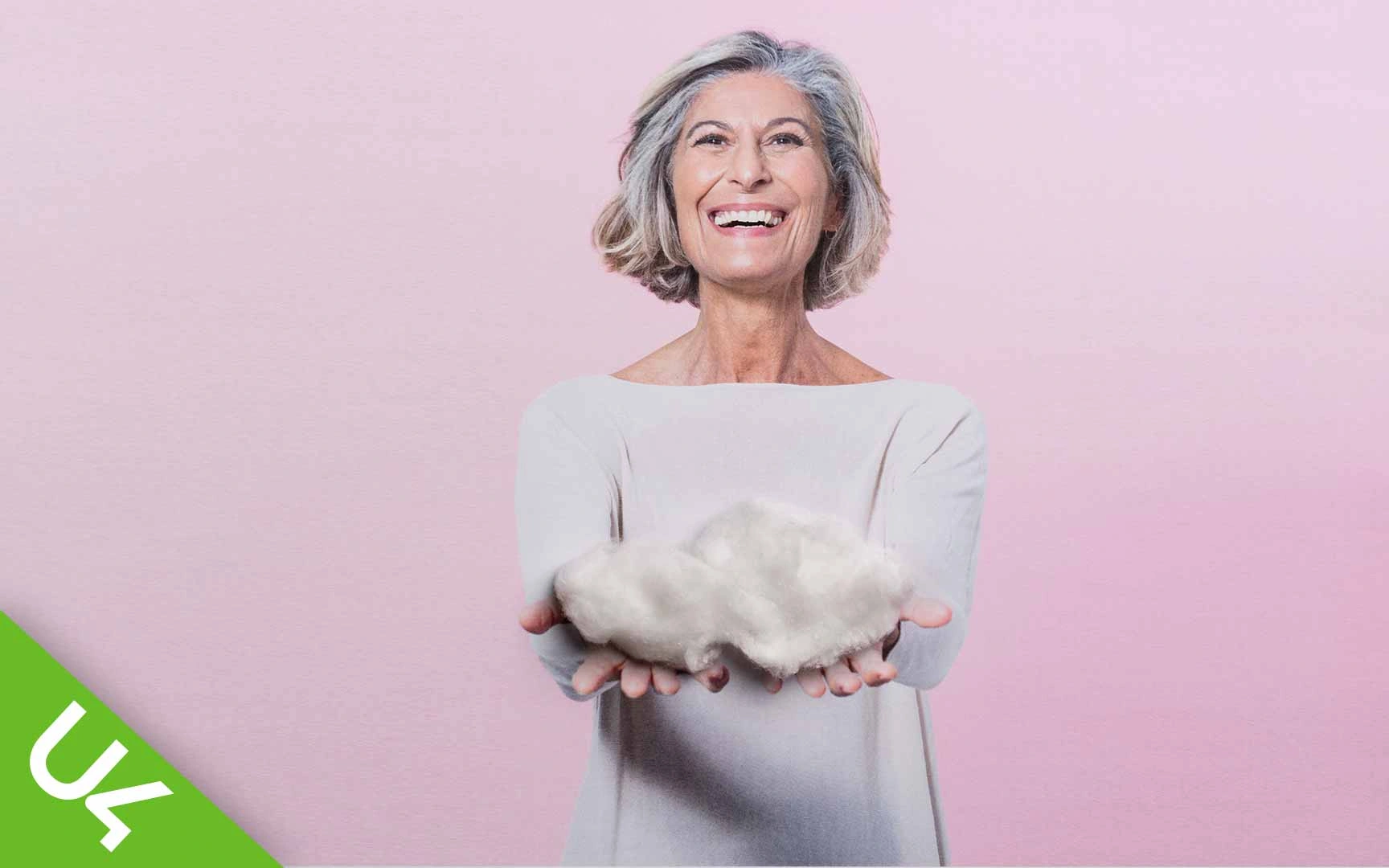 Woman with arms outstretched holding a cloud