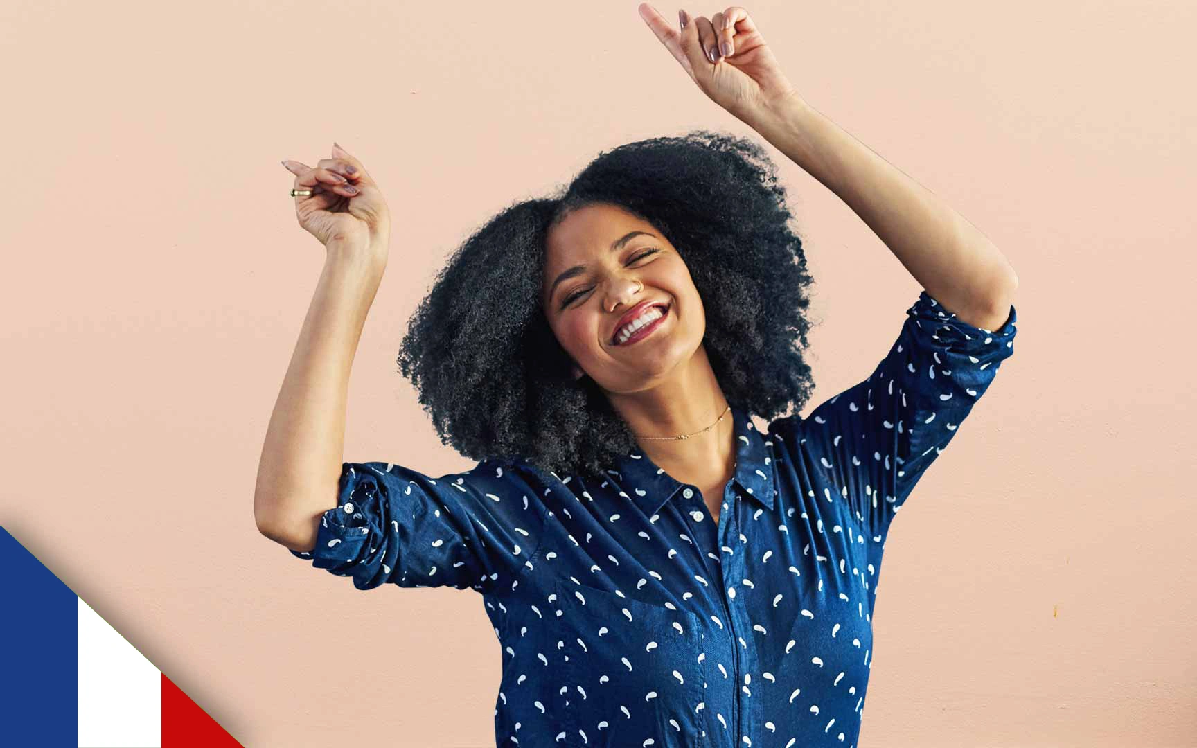 Smiling woman with both arms half raised and fists clenched in celebration