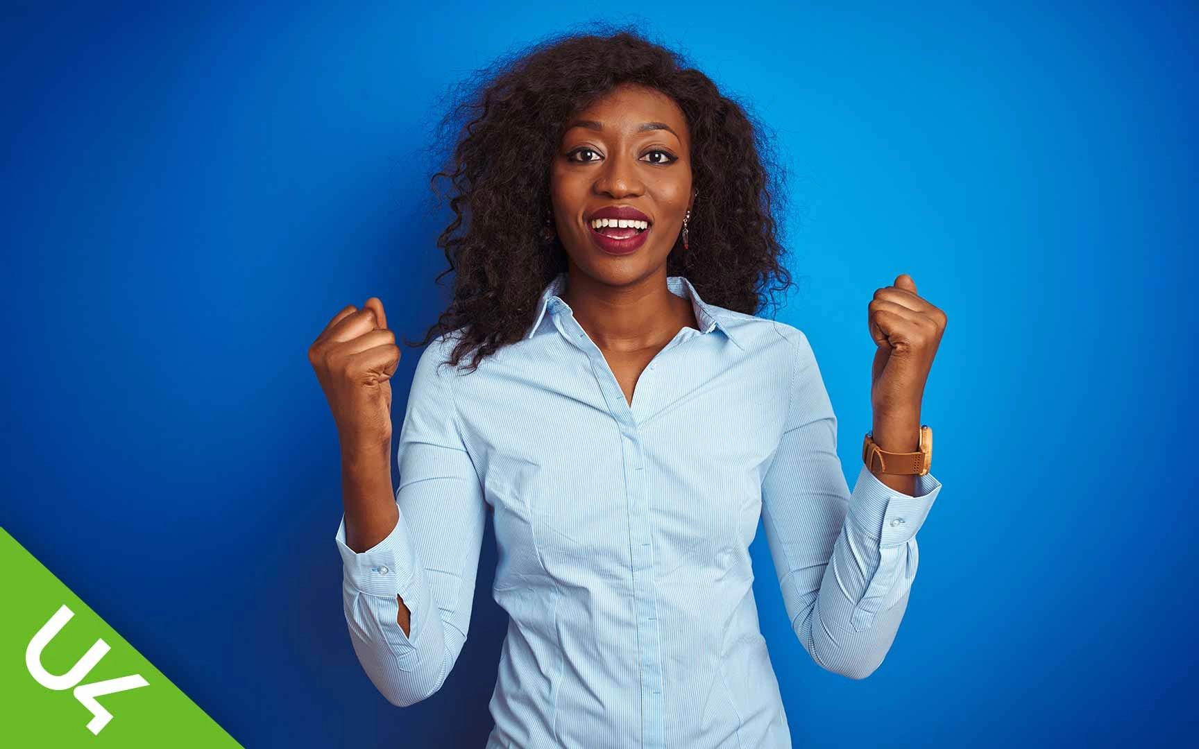 Woman smiling and with both hands half raised in celebration