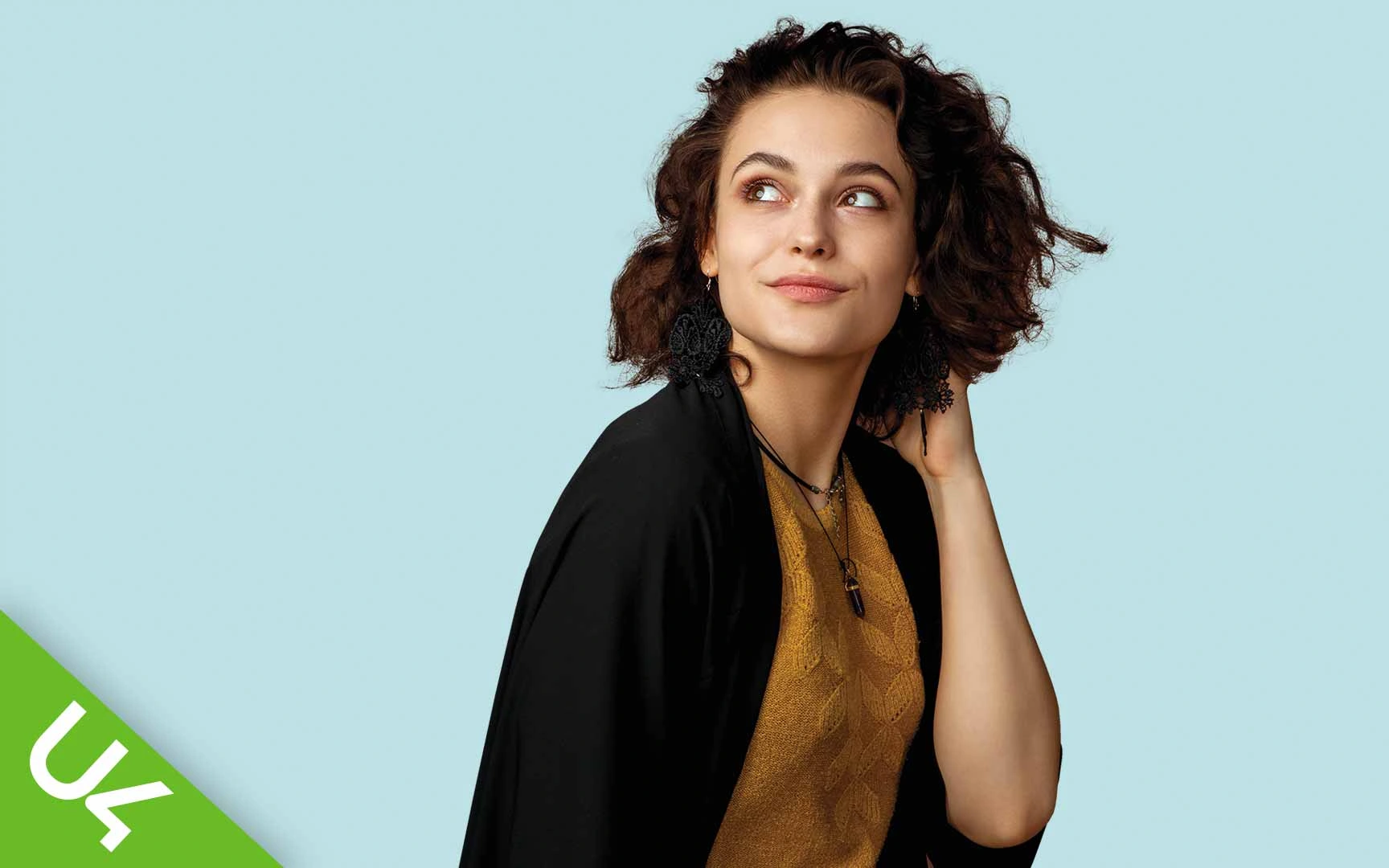 Woman with hand behind head - deep in thought and looking into the distance