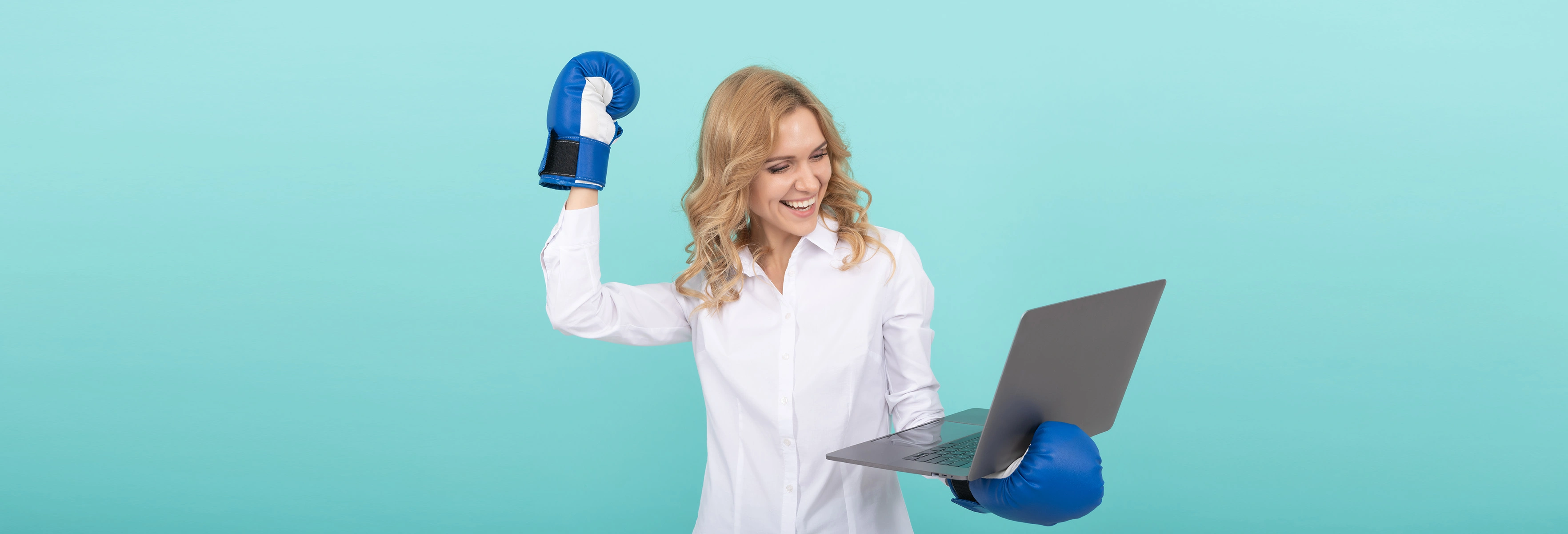 Woman with boxing gloves holding a computer